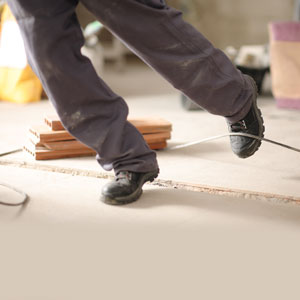 Construction worker tripping over cable, highlighting site dangers and legal rights.