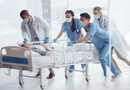 Medical staff rushing a patient on a hospital gurney, illustrating the immediate aftermath of an event requiring a personal injury claim
