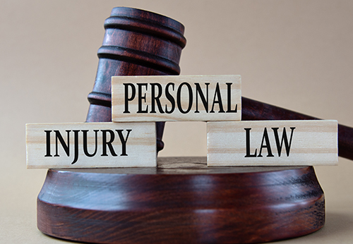 Gavel resting behind stacked blocks reading PERSONAL INJURY LAW, addressing questions for a lawyer in McAllen, TX